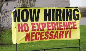 "Now Hiring" banner in front of a business